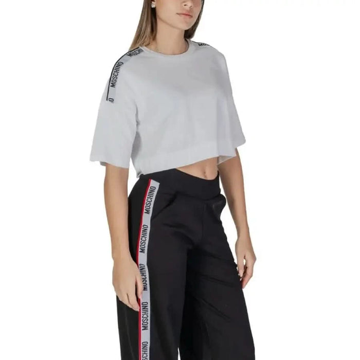 Athletic outfit with white cropped t-shirt and black striped track pants for women