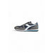 Athletic sneaker featuring gray, navy, and white color blocks with blue accent stripe