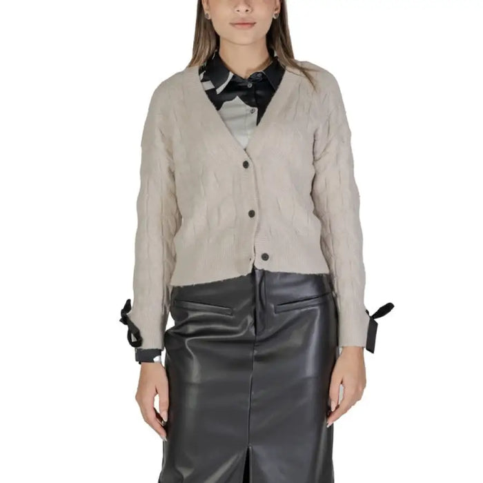 Beige cardigan sweater with black collar and cuffs over a leather skirt by Vila Clothes