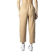 Tommy Hilfiger beige elastic-waist tapered trousers paired with white sneakers for women