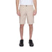 Beige knee-length Armani Exchange shorts paired with black sneakers for men