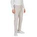 Beige Antony Morato men trousers styled with white sneakers and a white top