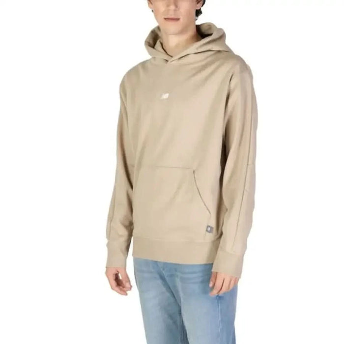 Beige New Balance pullover hoodie featuring front pocket and small logo design