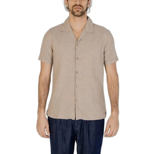 Hamaki-ho Men Shirt: Beige short-sleeved button-up worn by man with dark pants