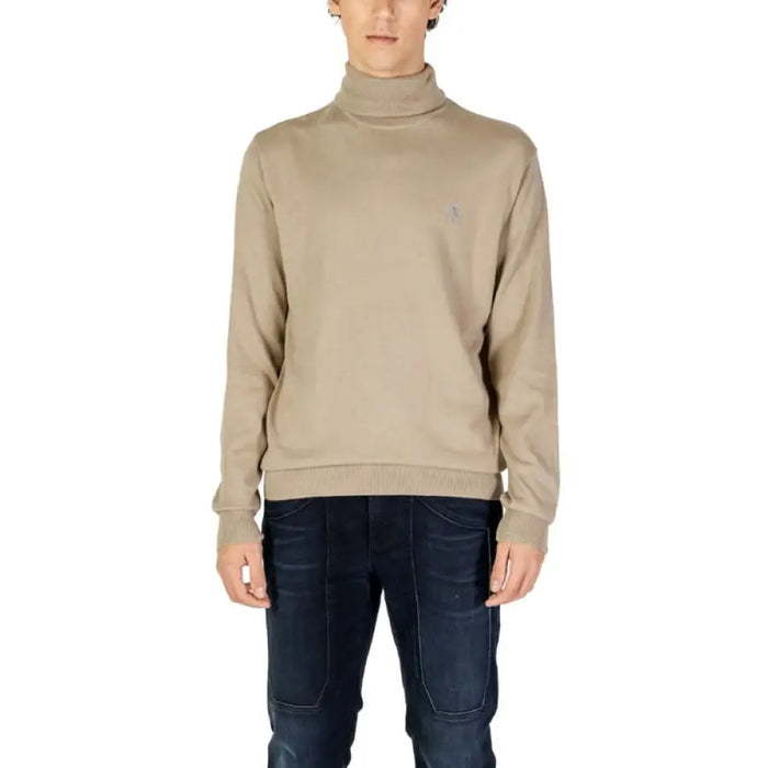 Beige turtleneck sweater paired with dark jeans from U.S. Polo Assn. Men’s Knitwear