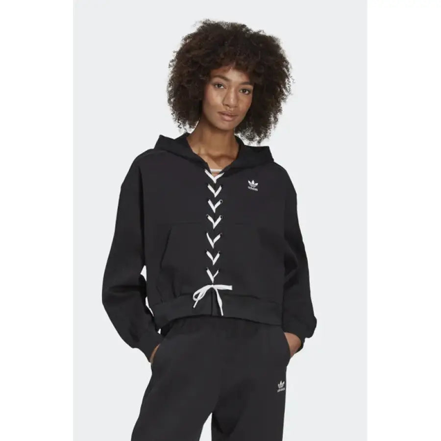 Black Adidas women’s hoodie with white lace-up detailing down the front