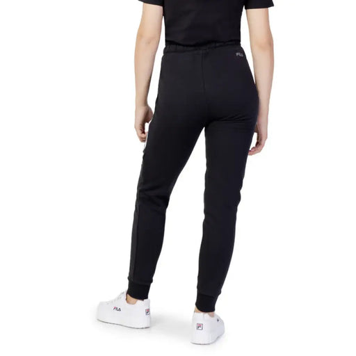 Black athletic jogger pants worn by a person from behind in Fila Women Trousers