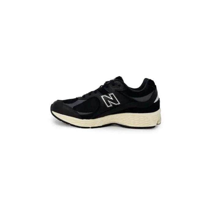 Black New Balance sneaker with white sole and logo for men’s footwear collection