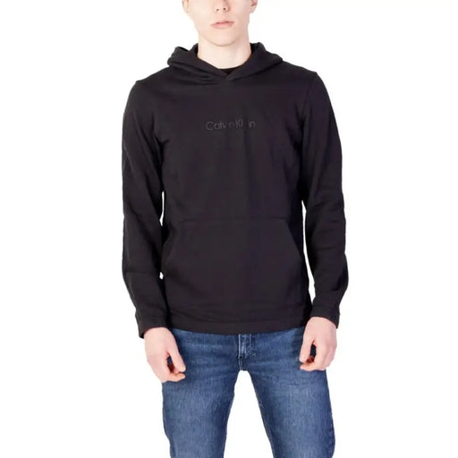 Black Calvin Klein hoodie paired with blue jeans from Calvin Klein Performance Men Sweatshirts