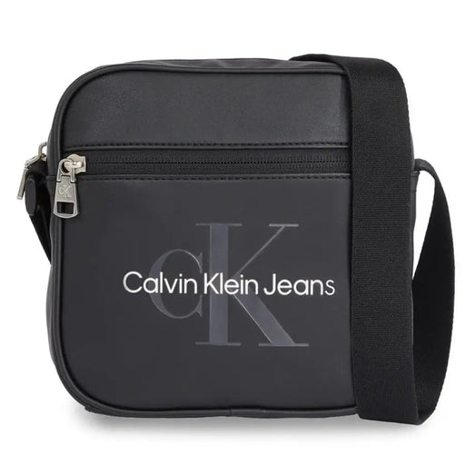 Black Calvin Klein Jeans messenger bag featuring zippered front pocket and adjustable strap