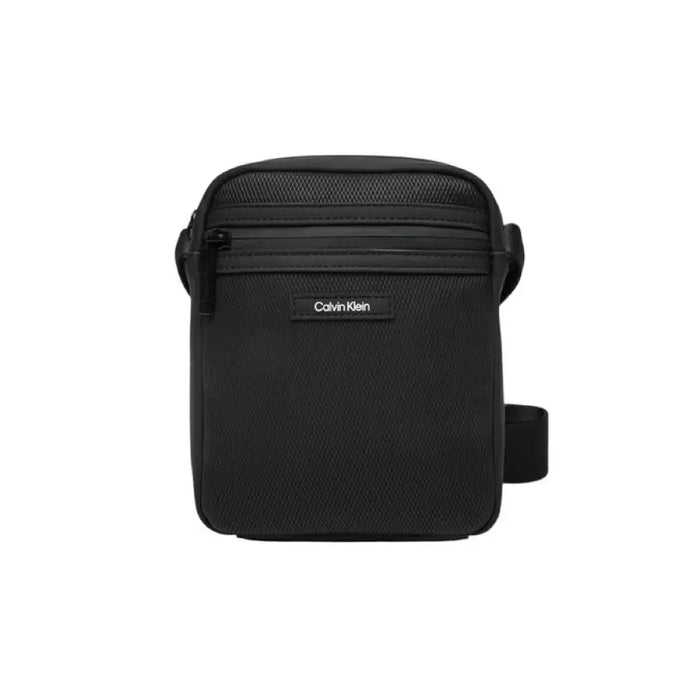 Black Calvin Klein crossbody messenger bag featuring zippered compartments for organization