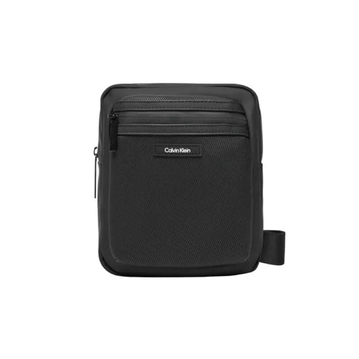 Black Calvin Klein crossbody messenger bag featuring multiple zippered compartments