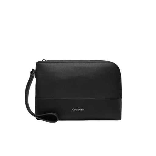 Black Calvin Klein leather clutch with wrist strap featured in Calvin Klein Black Shopper Bag