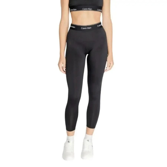 Black Calvin Klein Sport leggings showcased on a woman’s lower body