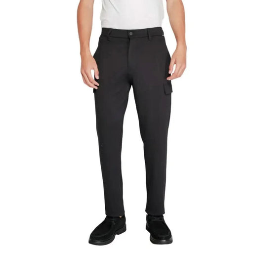 Black cargo pants, white shirt, and black shoes - Calvin Klein Men Trousers collection