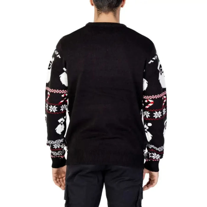 Black Christmas sweater featuring white penguin and snowflake patterns on sleeves