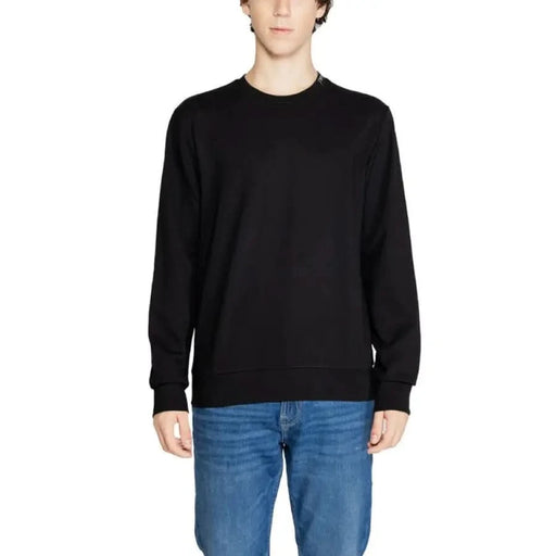 Black crew neck sweater with blue jeans in Emporio Armani Underwear men knitwear