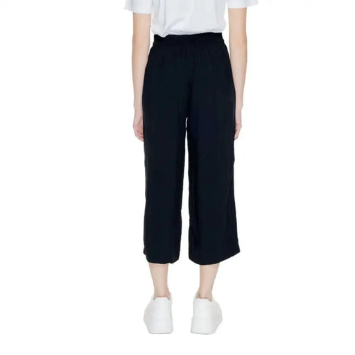 Black cropped wide-leg pants paired with white sneakers from Only Women Trousers