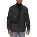 Black crossbody bag paired with dark turtleneck and utility jacket by Calvin Klein