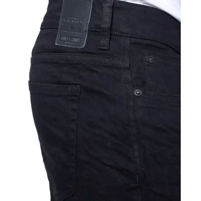 Black denim jeans featuring a leather brand patch on the waistband from Only & Sons