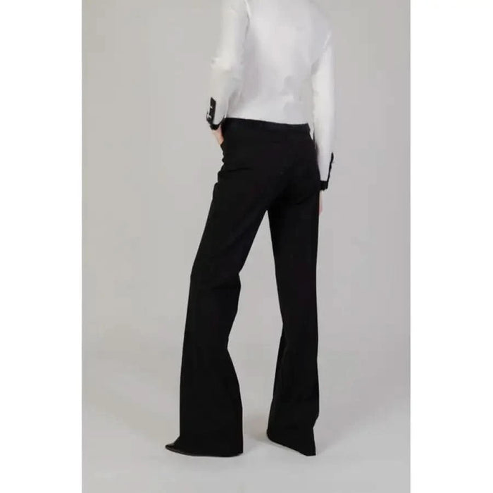 Black flared trousers paired with a white top from Morgan De Toi women’s collection