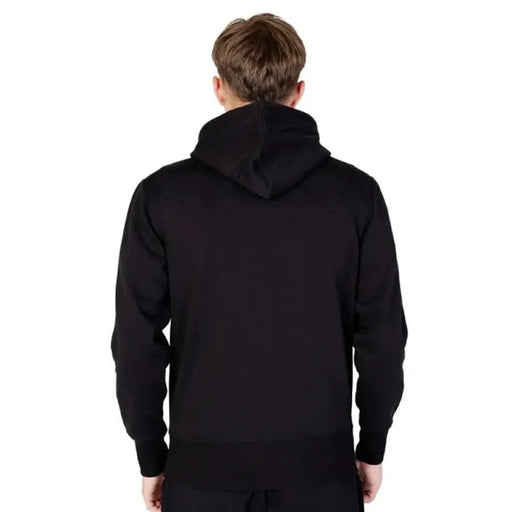 Black hooded sweatshirt on a person, showcasing Calvin Klein Jeans Men Sweatshirts