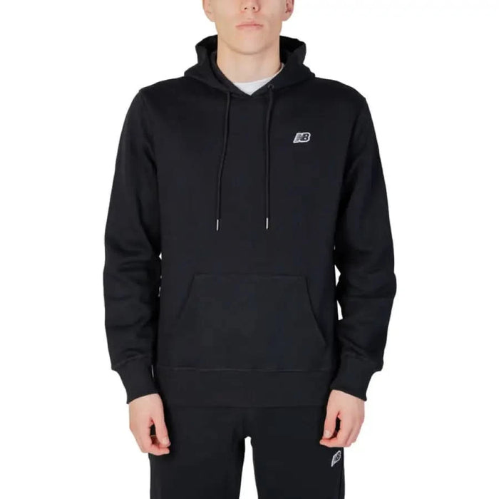 New Balance Men Sweatshirt in black, featuring a small chest logo on a hooded sweatshirt