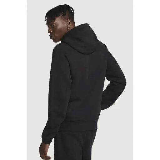 Side view of person wearing black hooded sweatshirt Nike Men Sweatshirts Nike