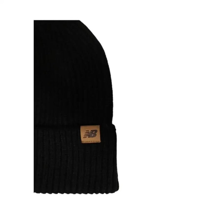 Black knit beanie featuring a New Balance leather patch logo for men’s casual wear