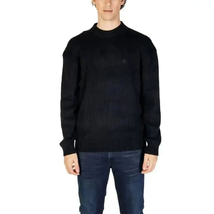 Black knit crewneck sweater paired with dark jeans from Calvin Klein Jeans Men Knitwear