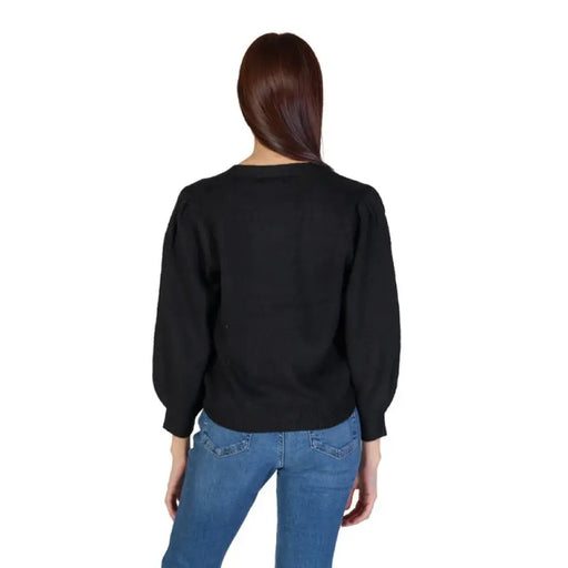 Black knit sweater with puff sleeves styled with blue jeans from Jacqueline De Yong