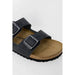 Black leather Birkenstock sandal with buckle straps and contoured footbed for women