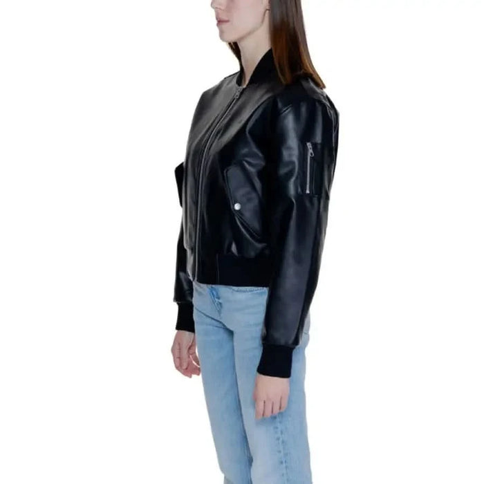 Calvin Klein Women’s Black Leather Bomber Jacket with Light Blue Jeans on Model