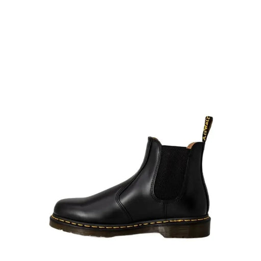 Black leather Chelsea boot with yellow stitching and pull tab by Dr. Martens