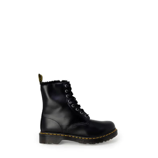 Black leather combat boot with yellow stitching and fur lining by Dr. Martens for women