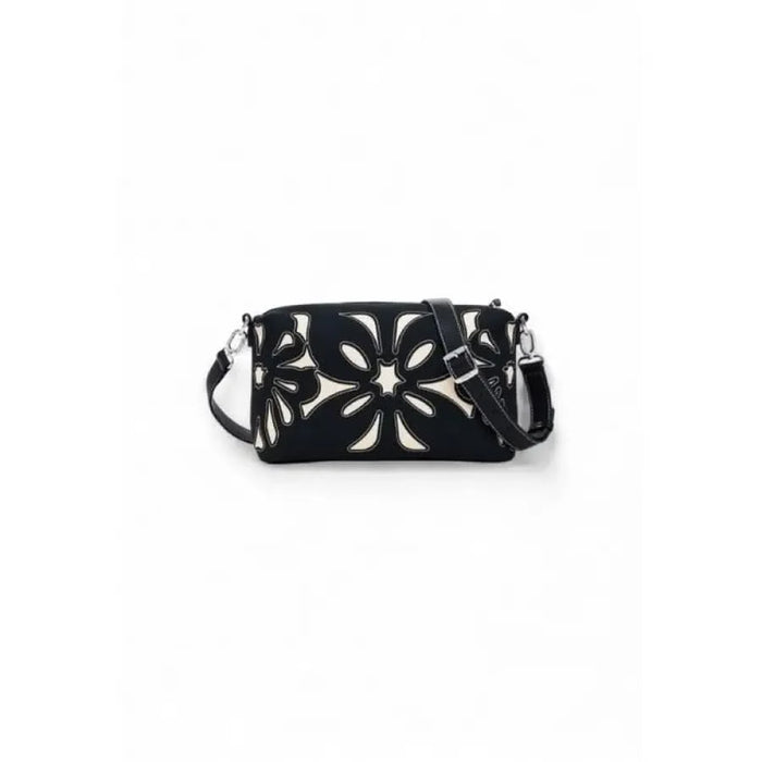 Black leather handbag with floral cutout design and silver hardware by Desigual