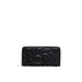 Black leather wallet with embossed design and zipper closure by Desigual for women