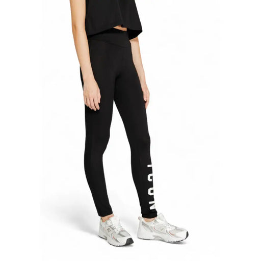 Black leggings with ICON text on leg styled with white sneakers, Icon Women Trousers