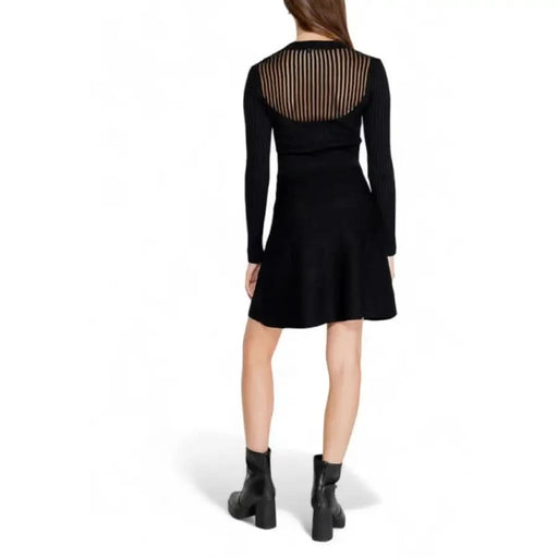 Black long-sleeved dress with sheer striped back panel and flared skirt by Morgan De Toi