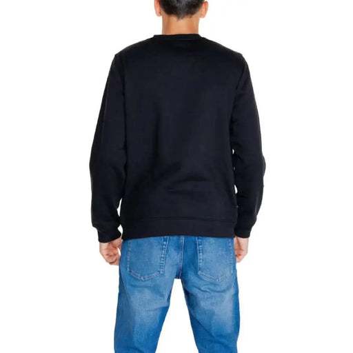 Back view of a Black long-sleeved sweatshirt with blue jeans from Calvin Klein Jeans Men collection