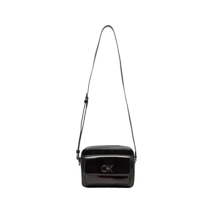 Black patent leather crossbody bag with adjustable strap by Calvin Klein