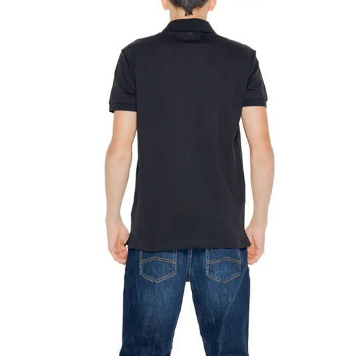 Black polo shirt on a person facing away, showcasing Calvin Klein Jeans design