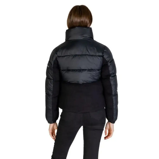 Back view of Columbia Women Jacket showcasing a black puffy winter jacket with high collar