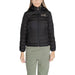 Black puffy winter jacket with EA7 logo for women, showcasing stylish warmth and comfort