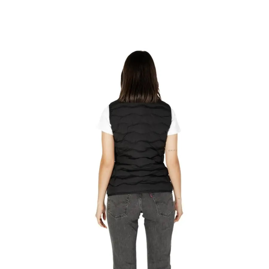 Ea7 Women Gilet: Black quilted vest over white t-shirt and gray jeans, back view