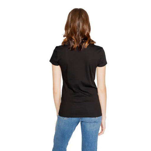 Black short-sleeved Armani Exchange Women T-Shirt worn by a person with brown wavy hair