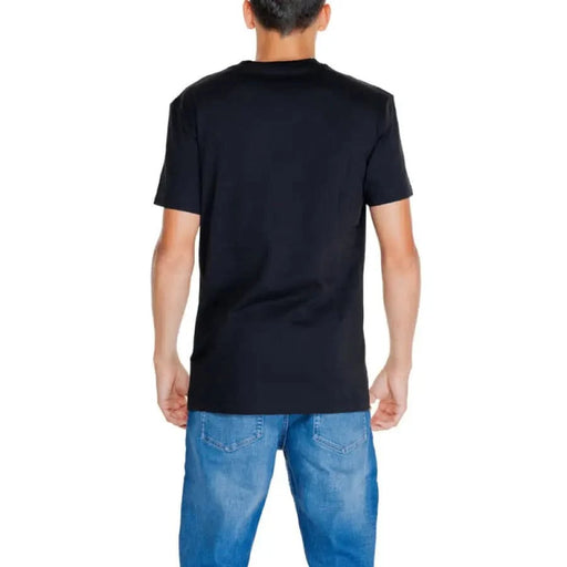 Black short-sleeved Calvin Klein Jeans t-shirt worn with blue jeans