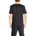 Black short-sleeved Calvin Klein Sport T-Shirt worn by a person from behind