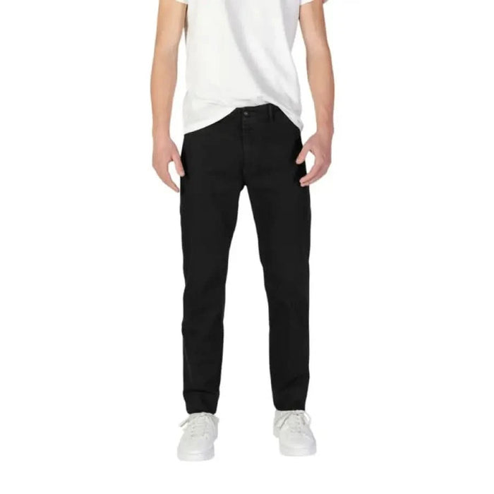 Black straight-leg pants with pockets styled with a white t-shirt and sneakers by Boss