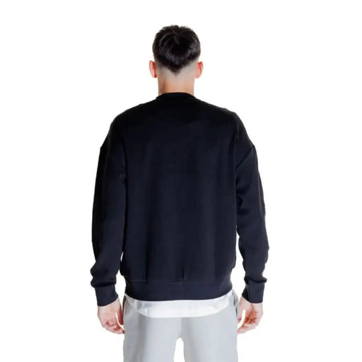 Black sweatshirt worn from behind; product: Calvin Klein - Calvin Klein Men Sweatshirts